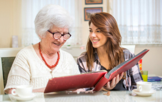 Senior woman with granddaughter looking at photo album