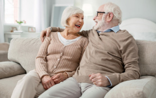 Senior couple on couch in independent living in oceanside