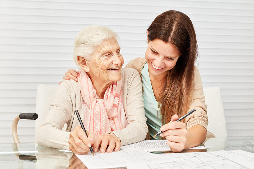 Senior woman with daughter looking at papers on table happy and smiling