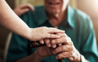 Hands, elderly man and woman in nursing home with support for retirement